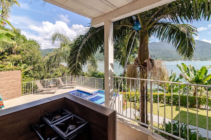 Área coberta com piscina e vista para o mar